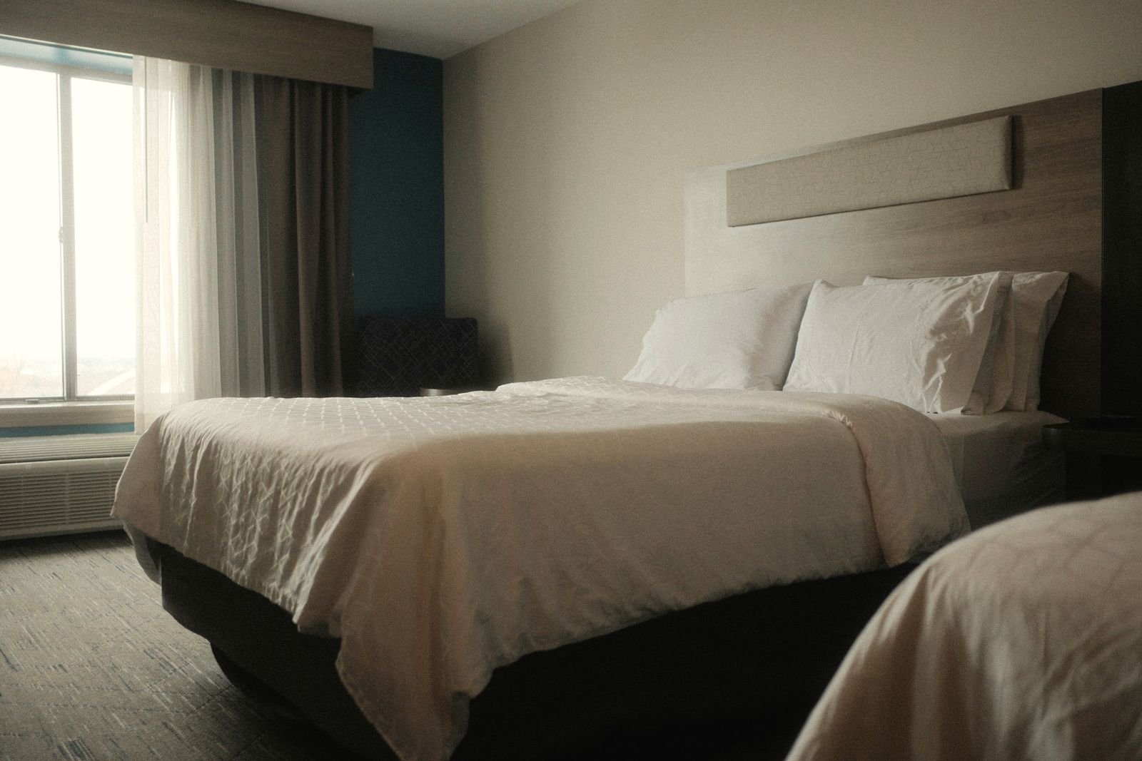 Room with two double beds and white linens